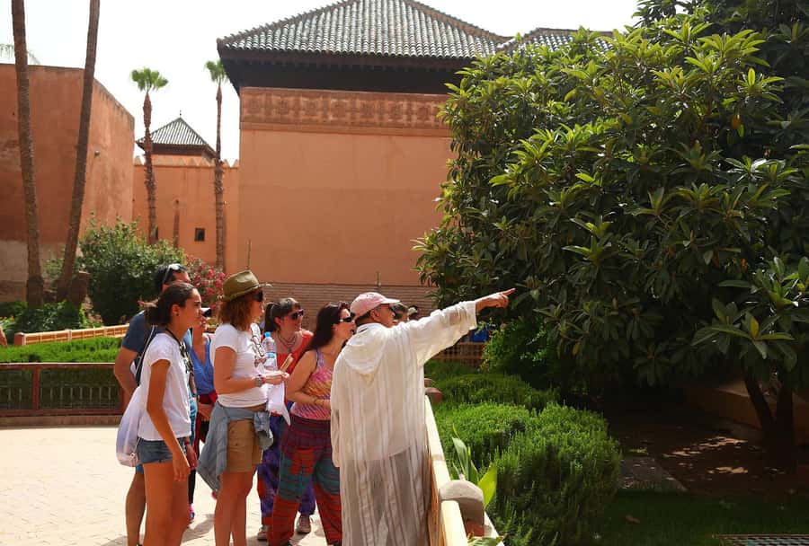 Marrakech: Bahia Palace, Saadian Tombs & Medina Guided Tour - Kasbah, Bab Agnaou, and the Koutoubia Mosque exterior: reading Marrakech in stone