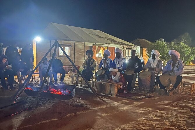 Merzouga Overnight Stay in a Berber Tent and Camel Ride - Berber camp at night: tents, dinner, drumming, and campfire vibes