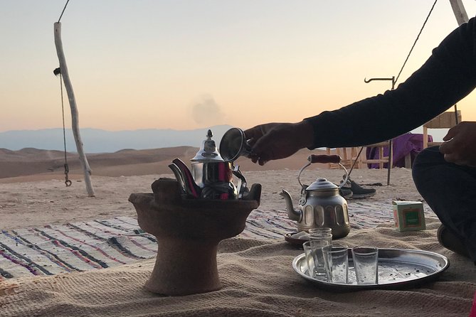 Sunset Camel ride Agafay desert including dinner and transport - Berber-tent dinner: Moroccan flavors under a night sky